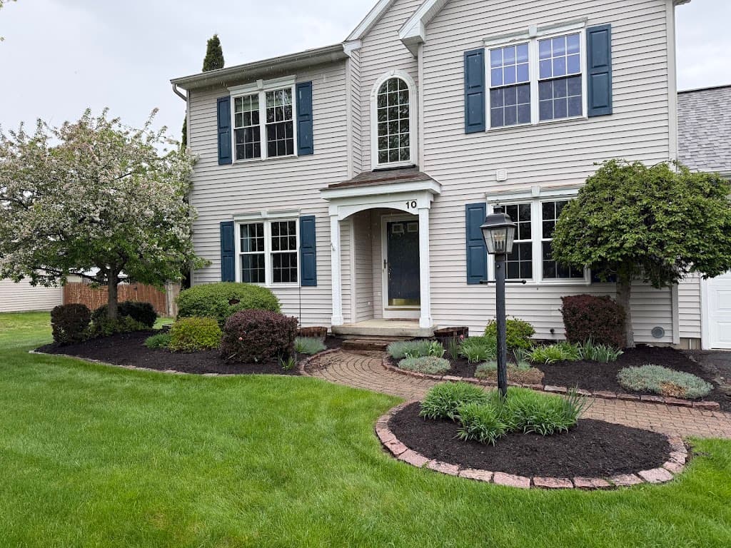 Front entry mulch bed with brick paver edging and foundation shrubs